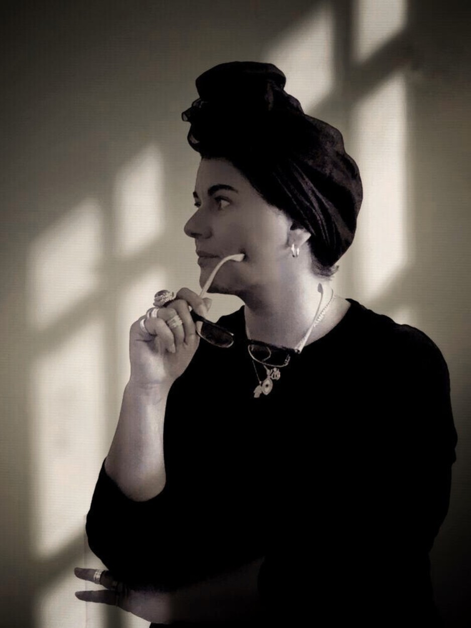 Asil Attar in profile, lit by window light